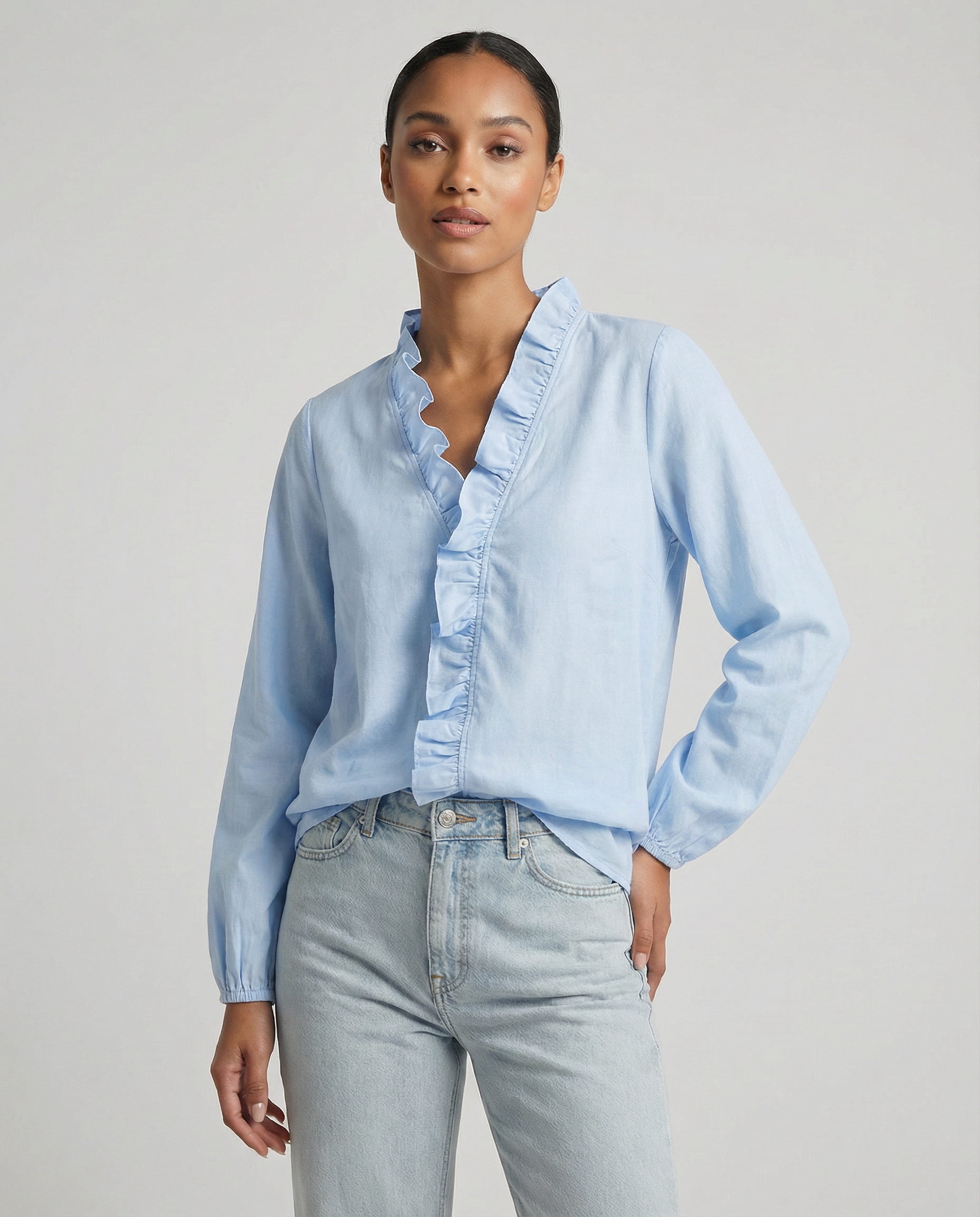 Light blue ruffle V-neck blouse with long sleeves and button-front