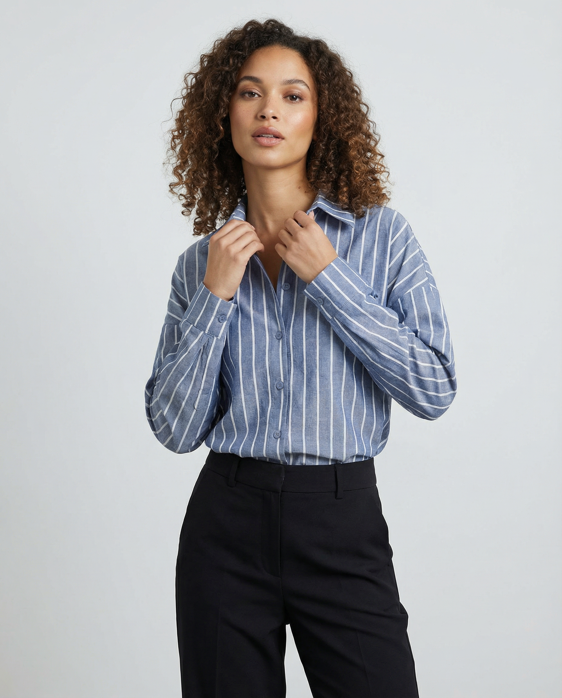 Blue striped button-down shirt with long sleeves and front button placket