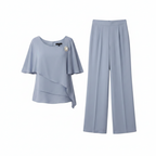 Light blue womens layered top and straight-leg trousers set, flat lay view
