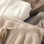 Close-up of ribbed waistband and drawstring on women’s knit lounge pants, light beige