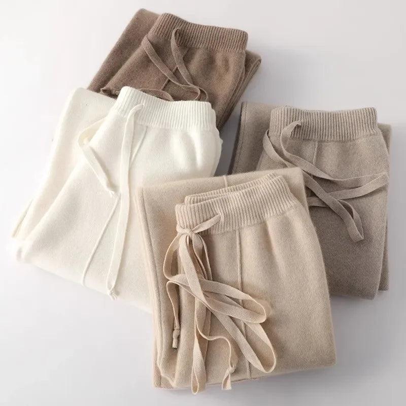 Folded women’s lounge pants set: white, light gray, taupe, and dark gray, with drawstrings