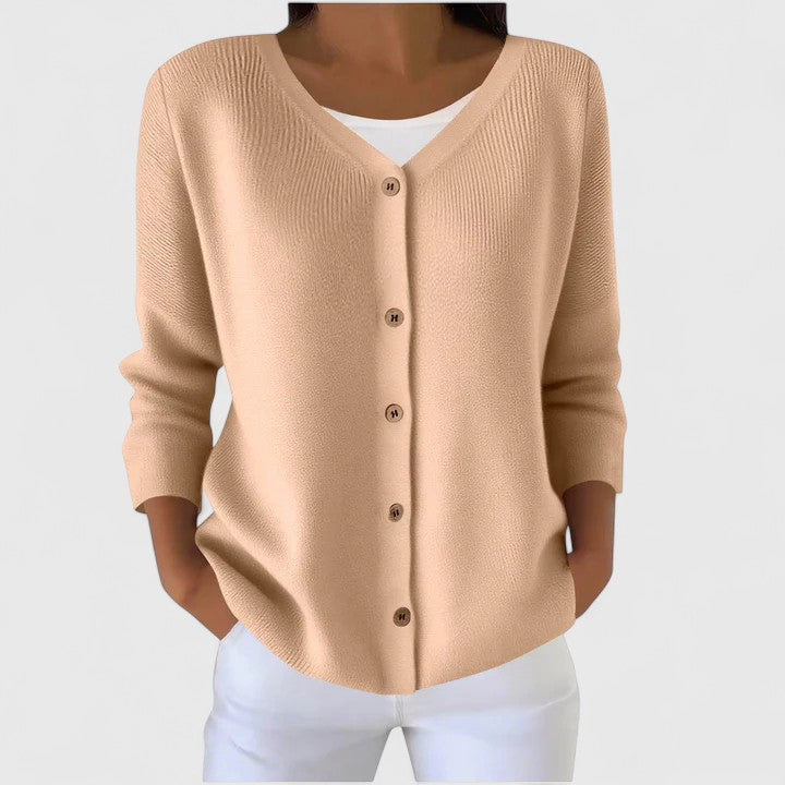 Beige knit cardigan with V-neck button front and three-quarter sleeves.