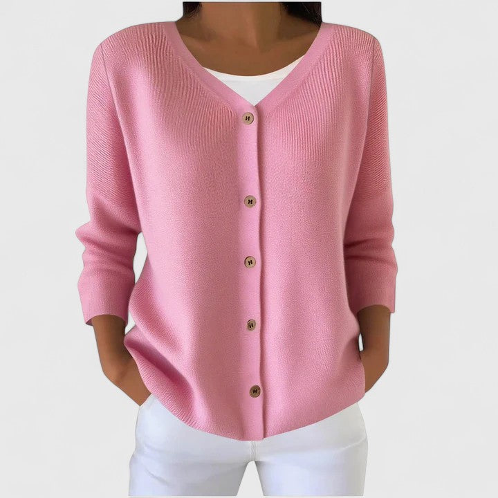Light pink knit cardigan with V-neck button front and three-quarter sleeves.