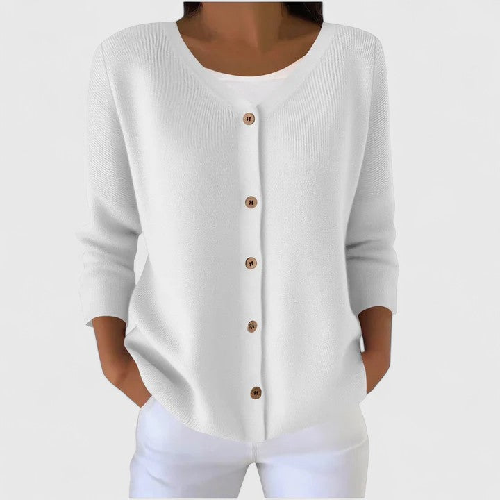 White knit cardigan with V-neck button front and three-quarter sleeves.