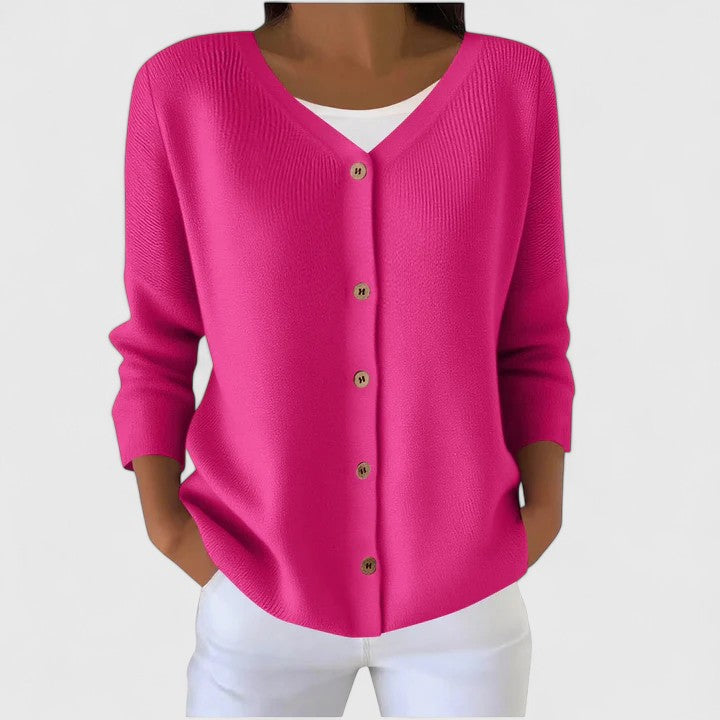 Pink knit cardigan with V-neck button front and three-quarter sleeves.