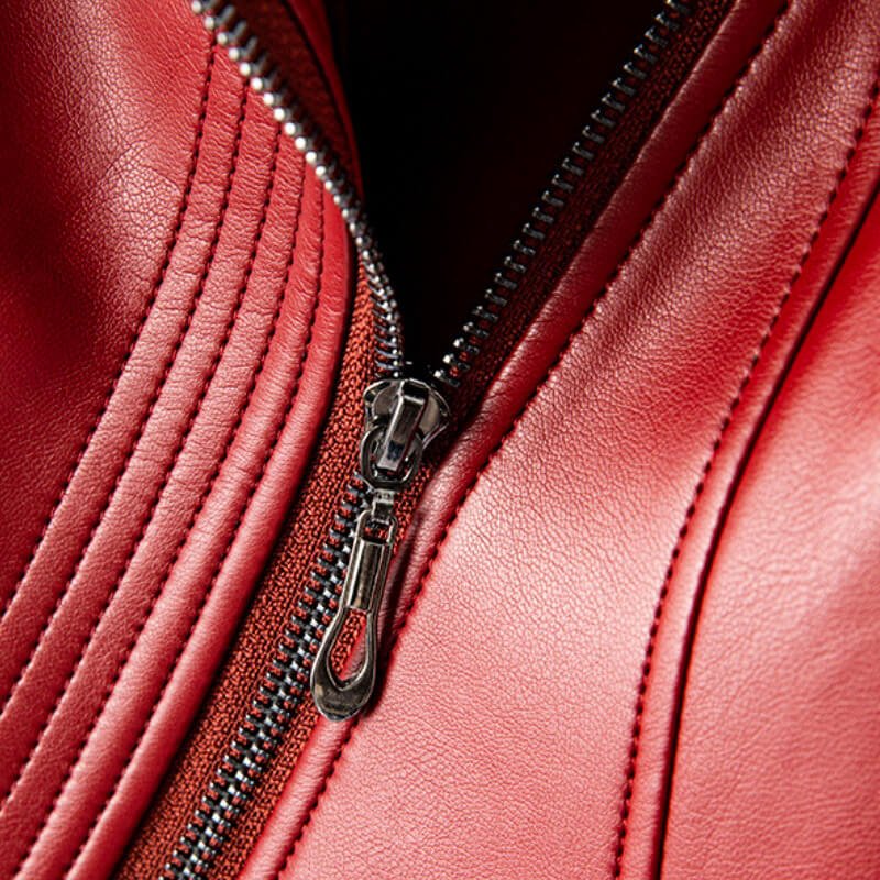 Crimson red leather jacket detail with silver zipper and stitched paneling