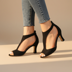 Supportive orthopedic black peep-toe heels with ankle strap, side view, slim heel