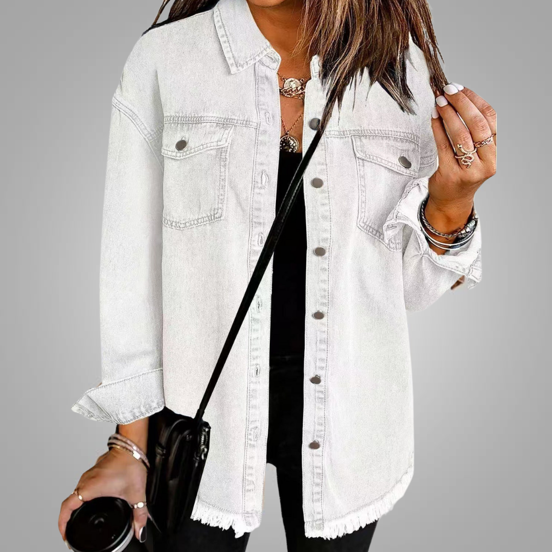 White denim jacket with chest pockets, button front, and frayed hem.