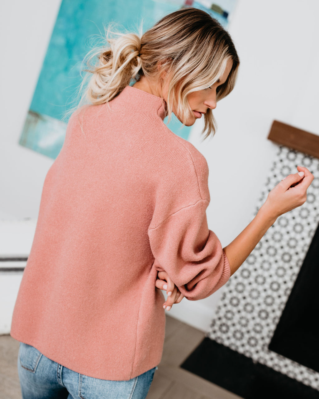 Blush-pink mock neck knit sweater with long sleeves and pullover design