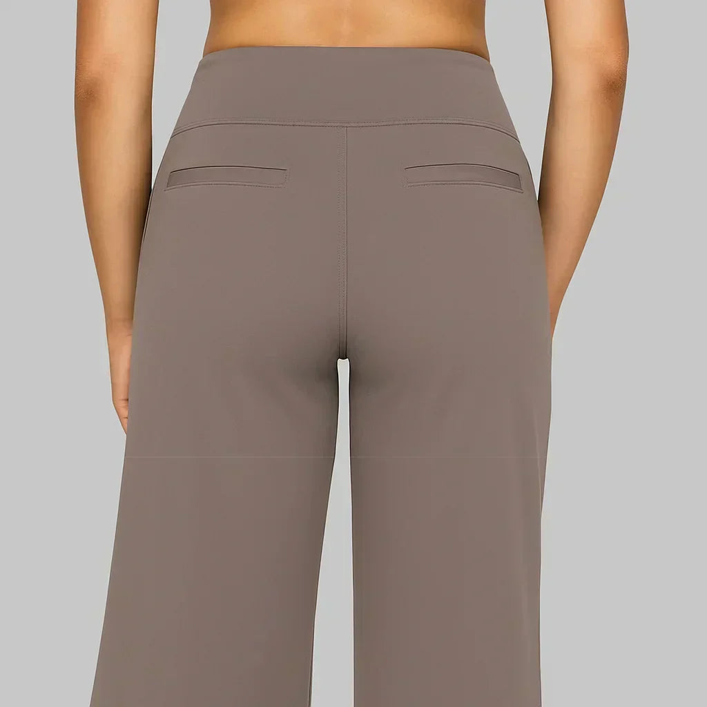 Taupe high-waisted yoga pants back view with two pocket seams and wide legs