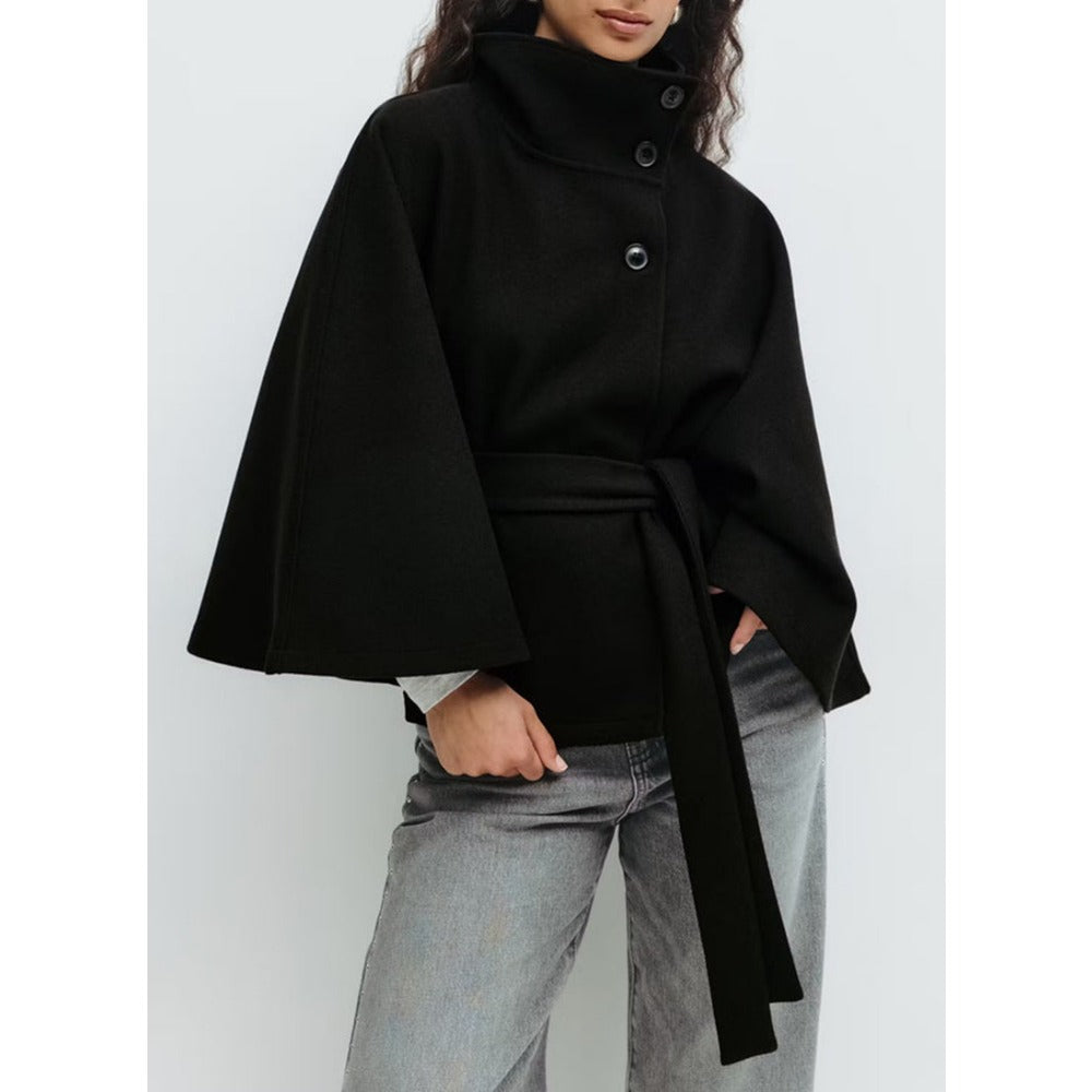 Women's high-collar cape coat in black, side view with belt tie and snap buttons