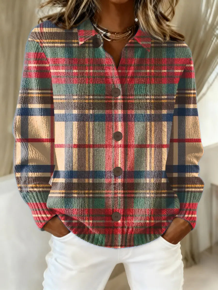 Red, navy, and tan plaid knit blouse with collar and button front with dark buttons.