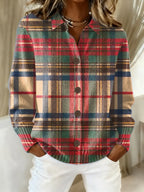 Red, navy, and tan plaid knit blouse with collar and button front with dark buttons.