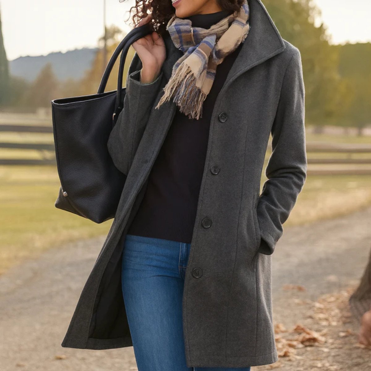 Grey women's mid-length single-breasted coat with button front and notched lapels