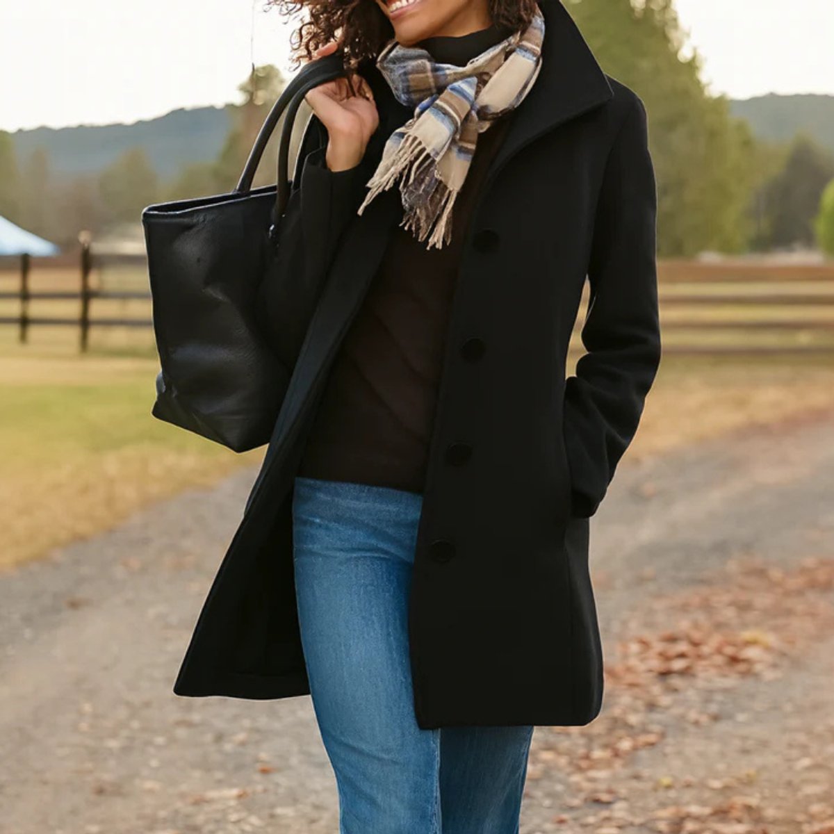 Black women's mid-length single-breasted coat with button front and notched lapels
