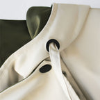 Two-tone hooded trench coat with white hood and drawstring, black eyelets