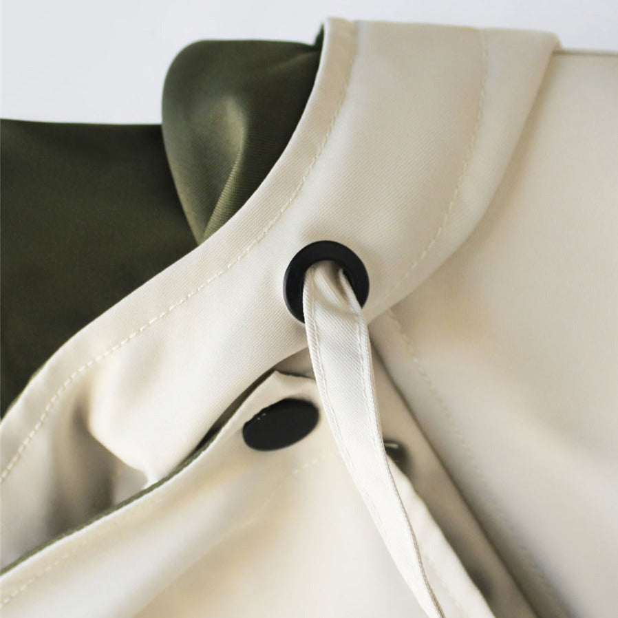 Two-tone hooded trench coat with white hood and drawstring, black eyelets