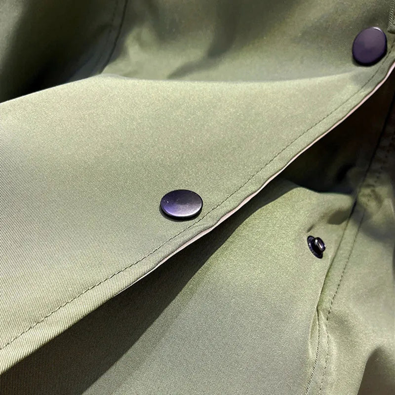 Trench coat chest and lapel area with dark button placket and green outer fabric