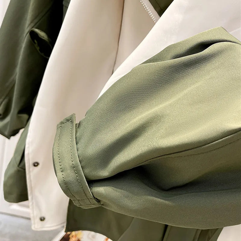 Two-tone trench coat sleeve and inner lining with green outer and cream panel