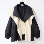 Two-tone hooded trench coat with black outer, cream panels, and snap front