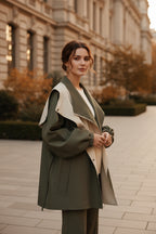 Two-tone hooded trench coat with olive green outer, cream panels, and snap front