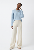 Light ivory wide-leg knit pants with soft pull-on waistband and roomy leg opening.