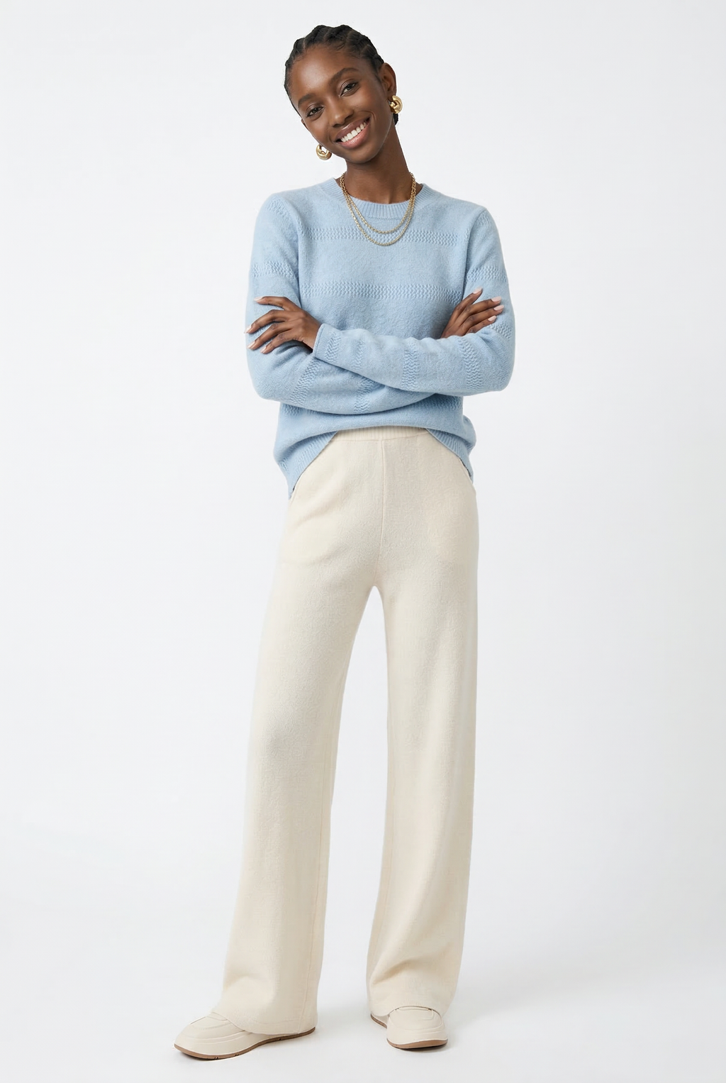 Women’s wide-leg knit pants in cream, full-length standing pose showing drape