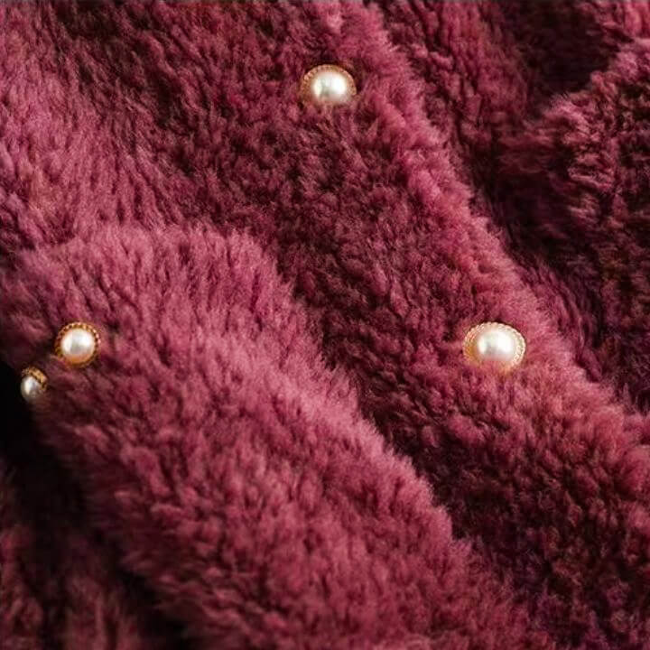 Burgundy shearling coat front with three pearl snap buttons, textured pile