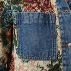 Denim front pocket detail with floral patchwork panels and stitched border