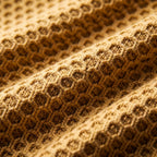 Honeycomb knit fabric texture close-up, sand beige
