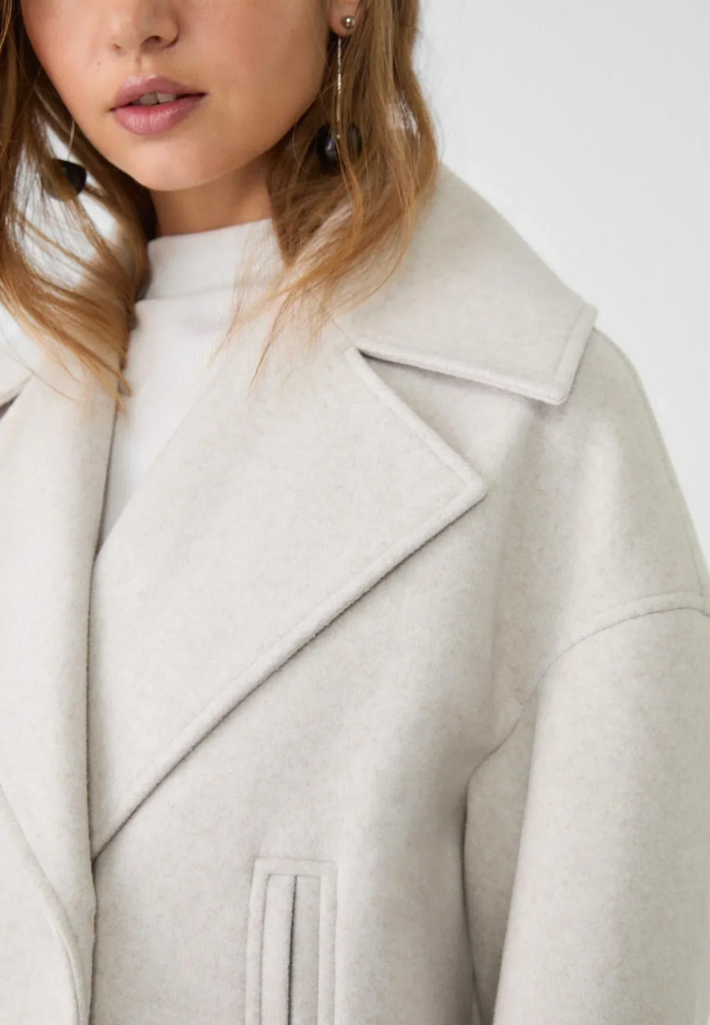 Off-white boxy cropped blazer with notched lapels and structured shoulder seams