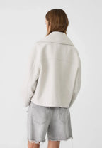 Back view of off-white boxy cropped double-breasted blazer with stand collar