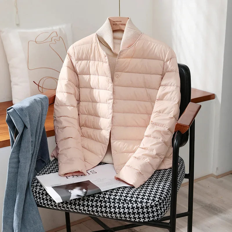 Lightweight quilted jacket in pale pink with ribbed stand collar and snap front