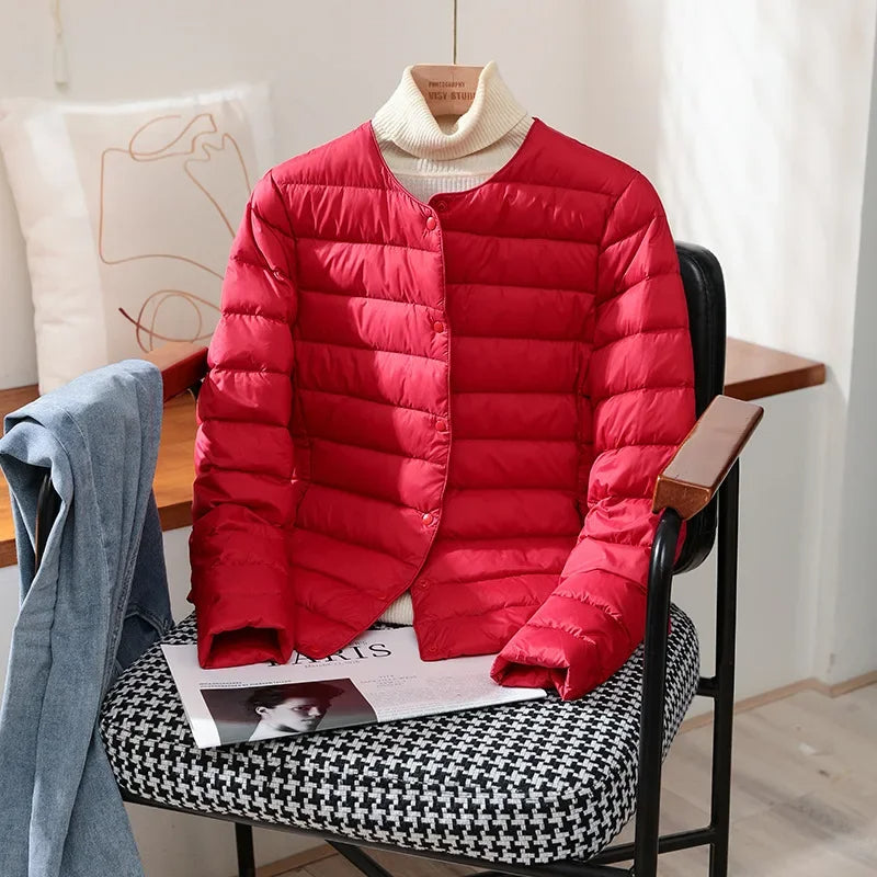 Lightweight quilted jacket in bright red with ribbed stand collar and snap front