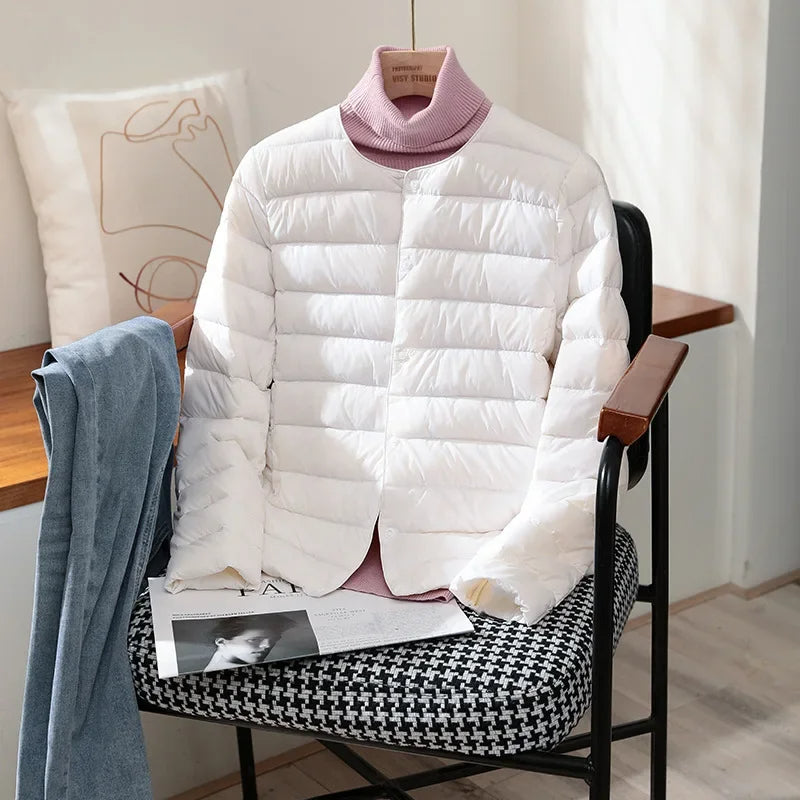 Lightweight quilted jacket in white with mauve ribbed stand collar and snap front