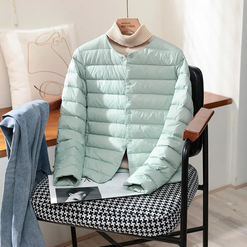 Lightweight quilted jacket in light aqua with ribbed stand collar and snap front