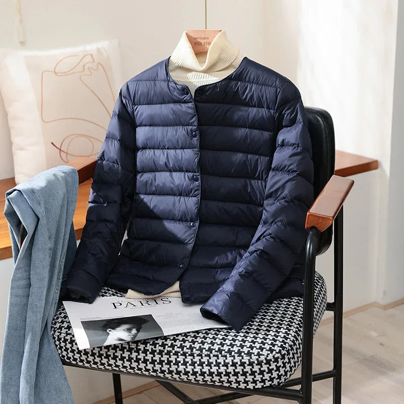 Lightweight quilted jacket in navy with ribbed stand collar and snap front