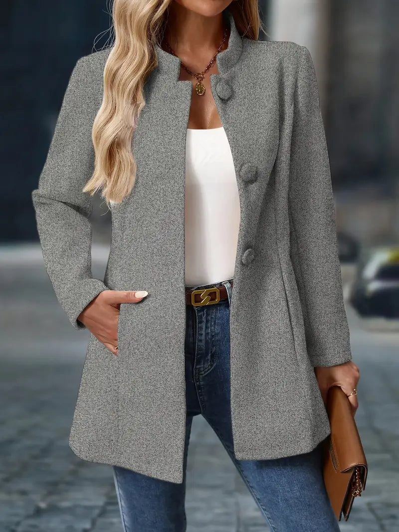 Grey mid-length winter coat with buttoned stand collar and front pockets, long sleeves