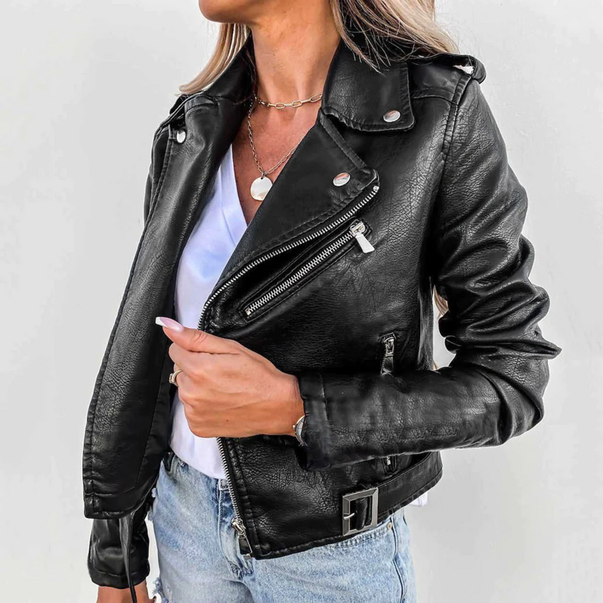 Women’s black leather biker jacket with stand collar, diagonal zip, and snap pockets