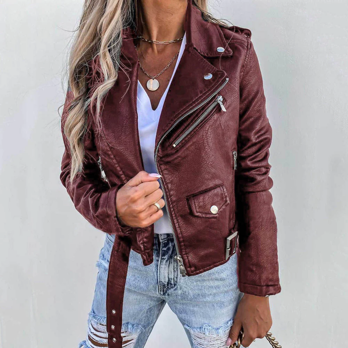 Women’s burgundy leather jacket with stand collar, front zip, and buttoned chest pocket