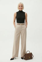 Light beige high-waisted wide-leg trousers with belt and wide, flowing legs