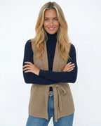 Camel merino wool belted sweater vest with V-neck and waist tie, sleeveless layering piece.