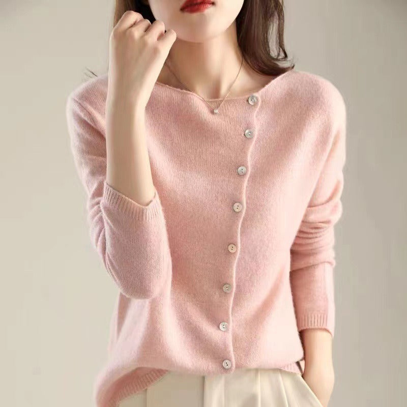 Blush pink knit sweater with V-neck, front button placket, and ribbed sleeve cuffs