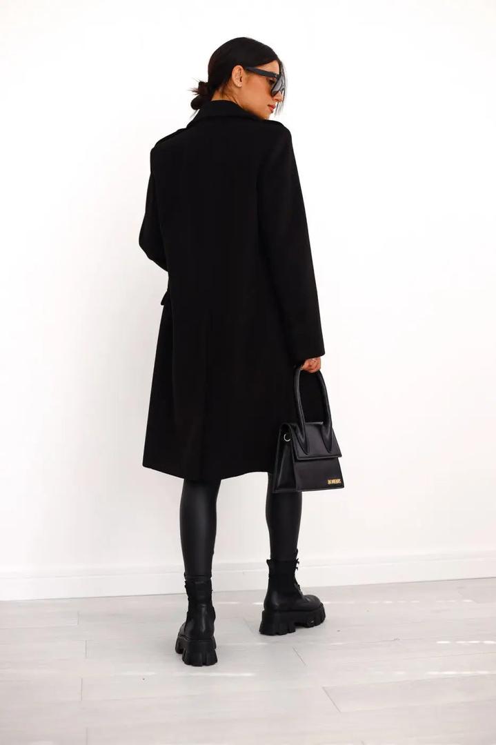 Black double-breasted wool coat with buttons, long sleeves, flap pockets, knee length