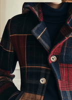Plaid wool jacket close-up with cream-lined seams and button front