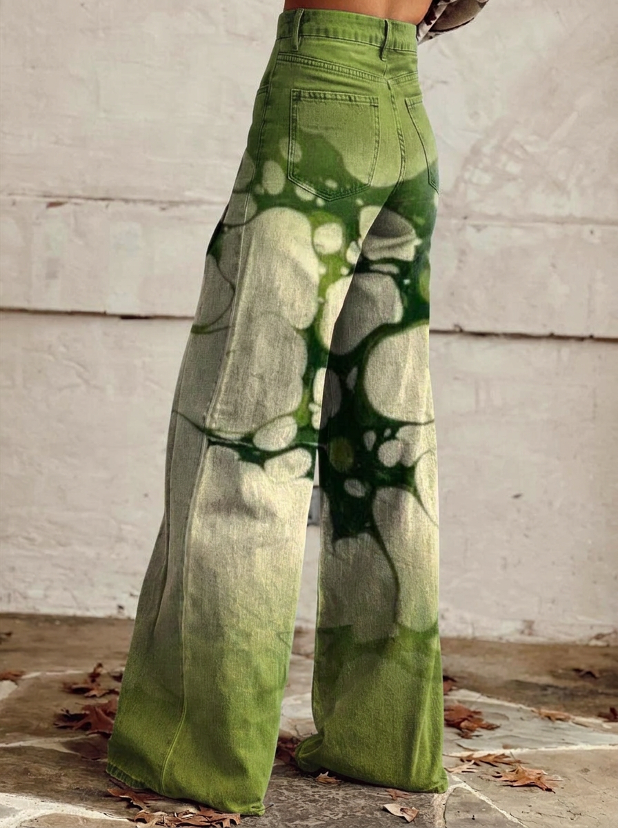 Wide-leg jeans with green abstract print, back view from hips to hem