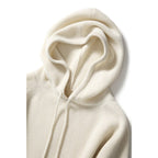 Women’s white pullover hoodie close-up with drawstring hood and kangaroo pocket