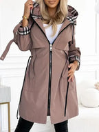 Women's taupe zip coat with front zipper, pockets, and black-trim plaid hood lining