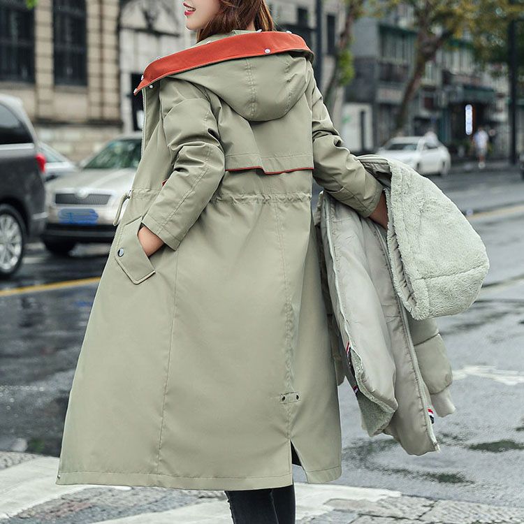 Pea green waterproof women's parka jacket with orange trim and fur-lined hood