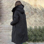 Black waterproof women's parka jacket with fur-lined hood and side flap pockets